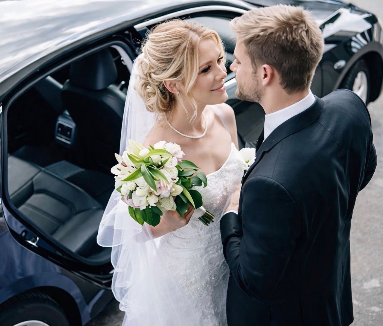 Bride and groom entering wedding limo in Boston with chauffeur service